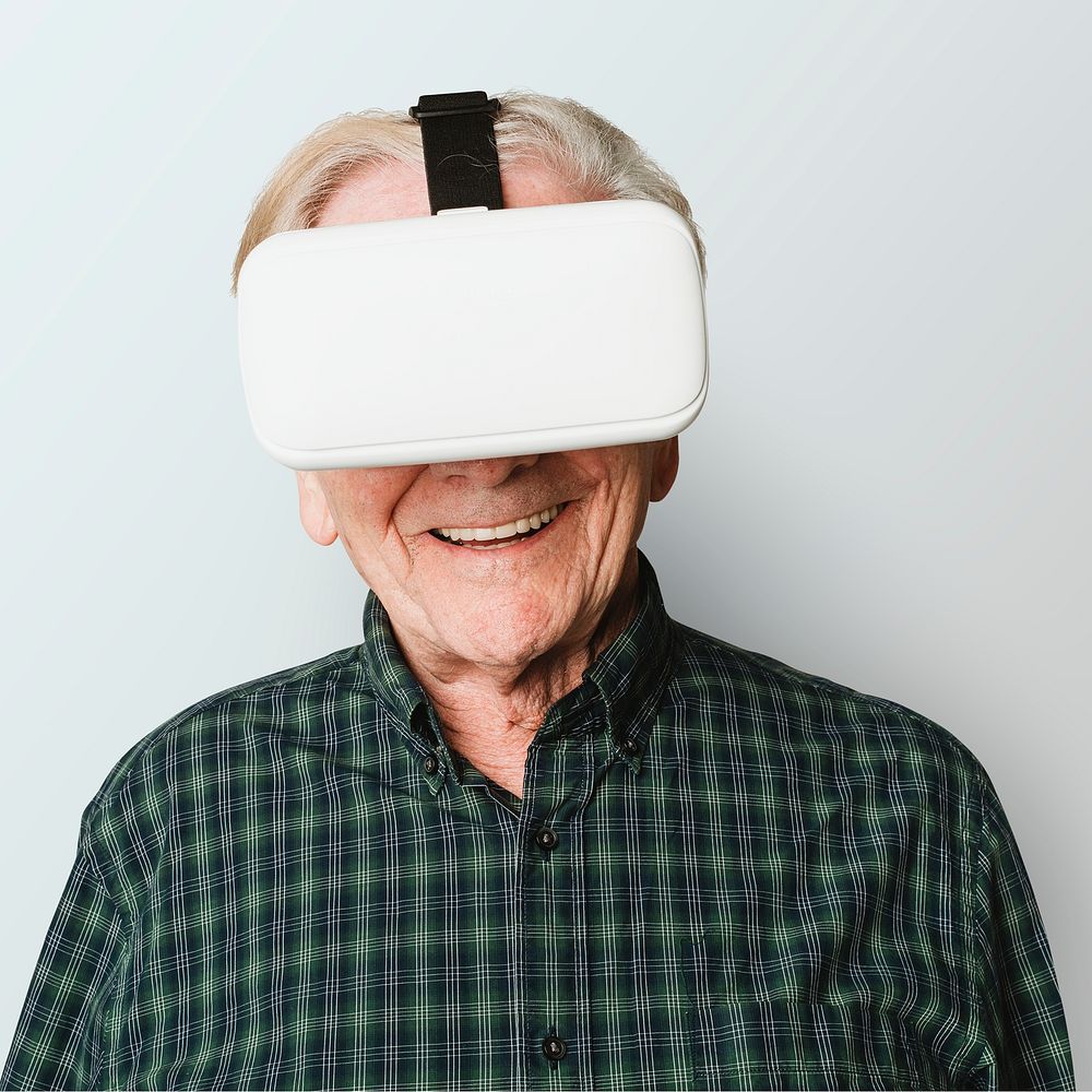 Cheerful senior man wearing  virtual reality goggles mockup