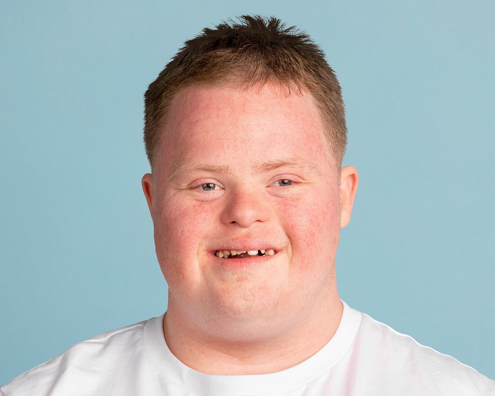 Young down syndrome man, smiling face portrait psd