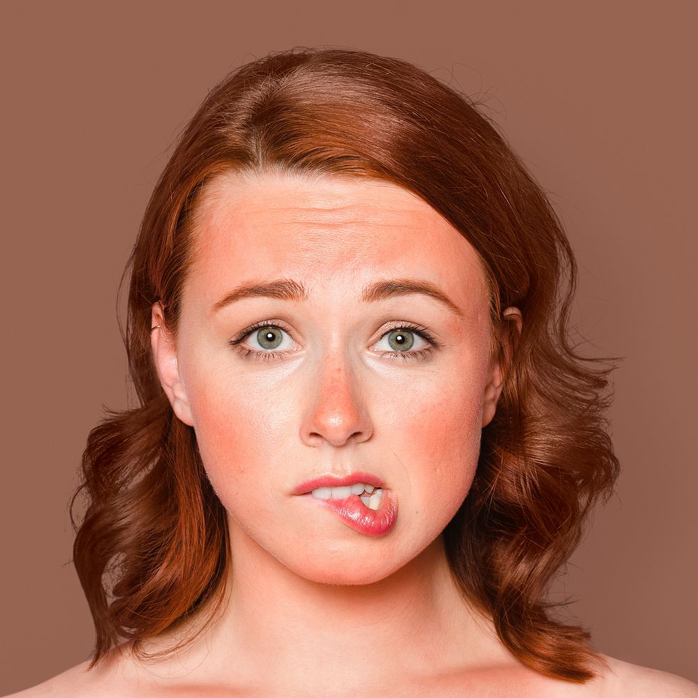 Sunburnt woman face portrait, biting her lips psd