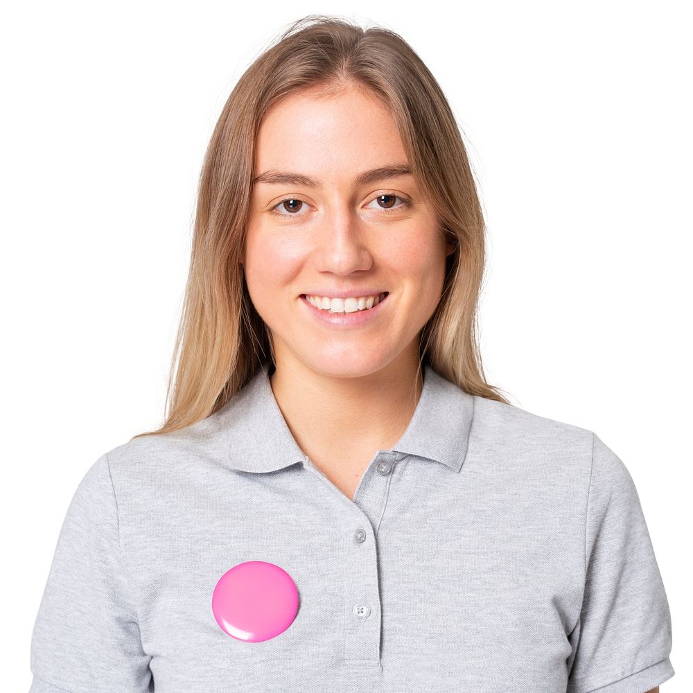 Happy woman in gray polo shirt with pink pin button