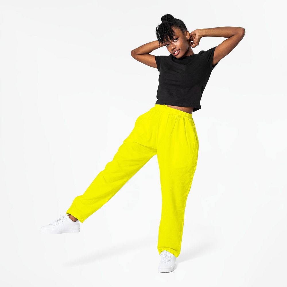 Woman in neon yellow sweatpants and black tee street apparel