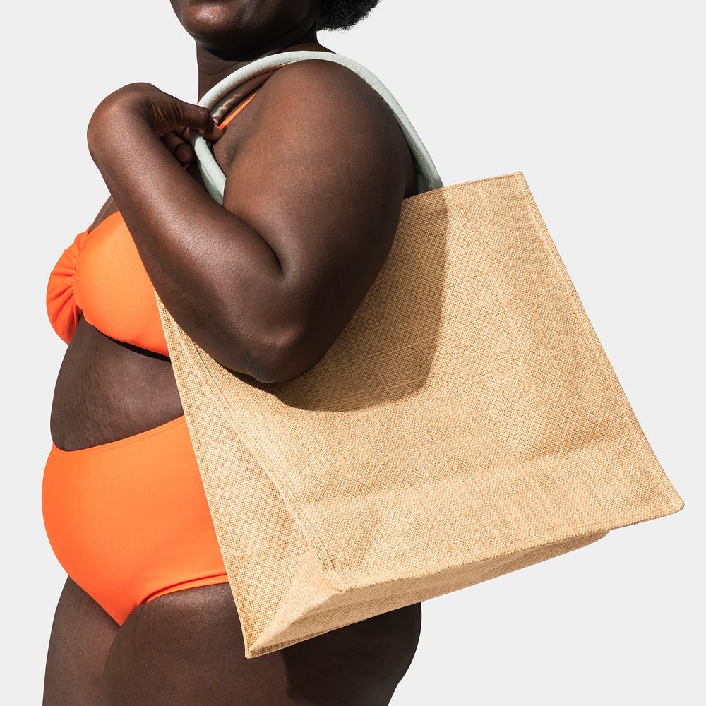African American woman carrying a tote bag, ready for the beach 