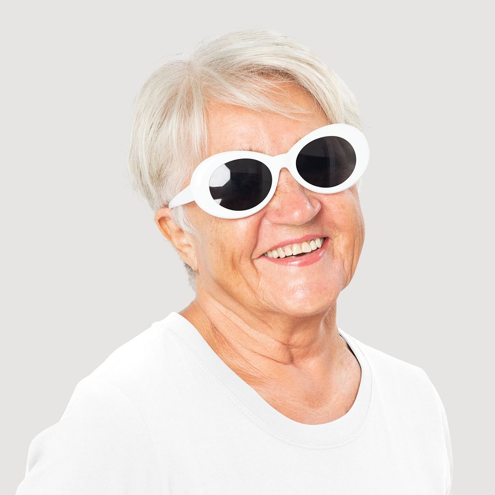 Happy senior woman wearing white oval sunglasses for summer apparel portrait