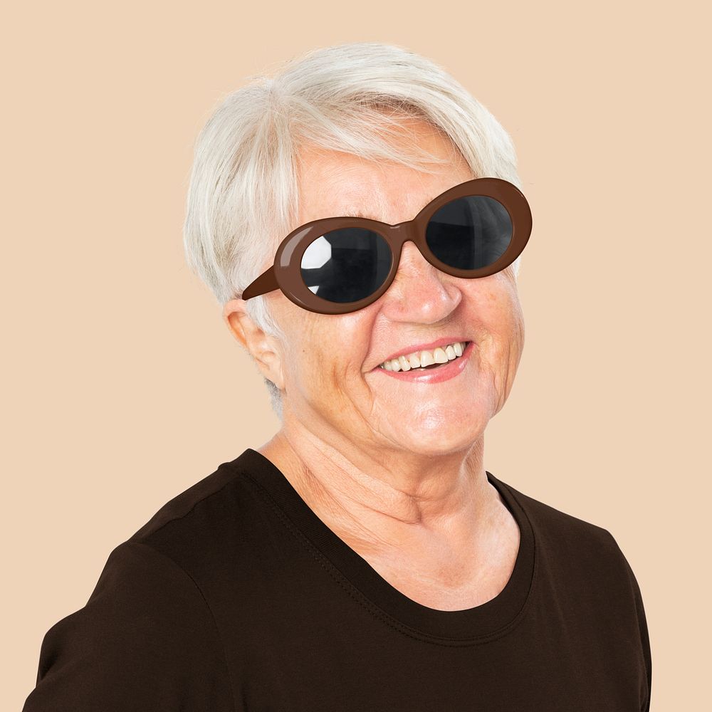Happy senior woman wearing black oval sunglasses for summer apparel portrait