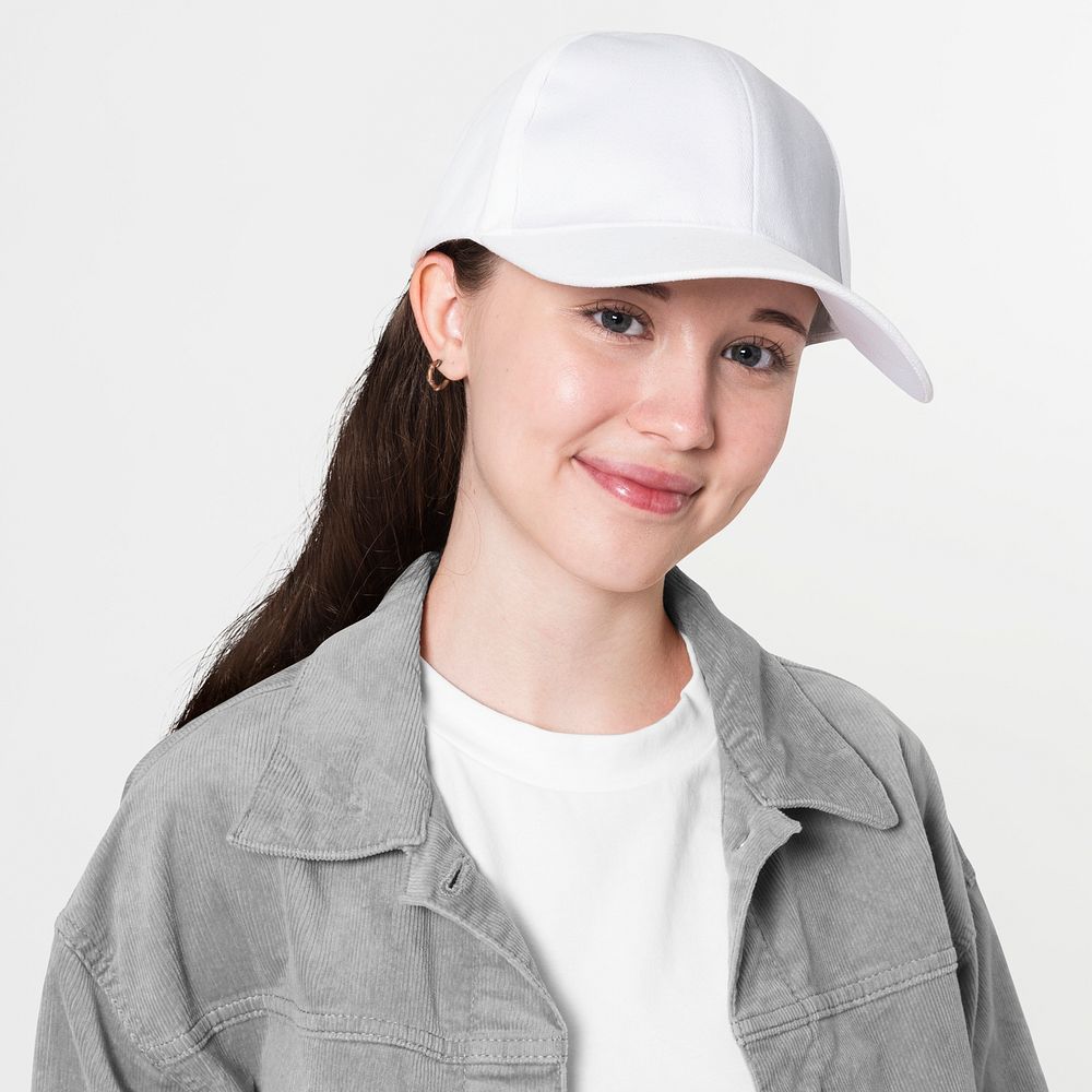 Teenage girl in stylish outfit and white cap studio portrait for youth apparel shoot
