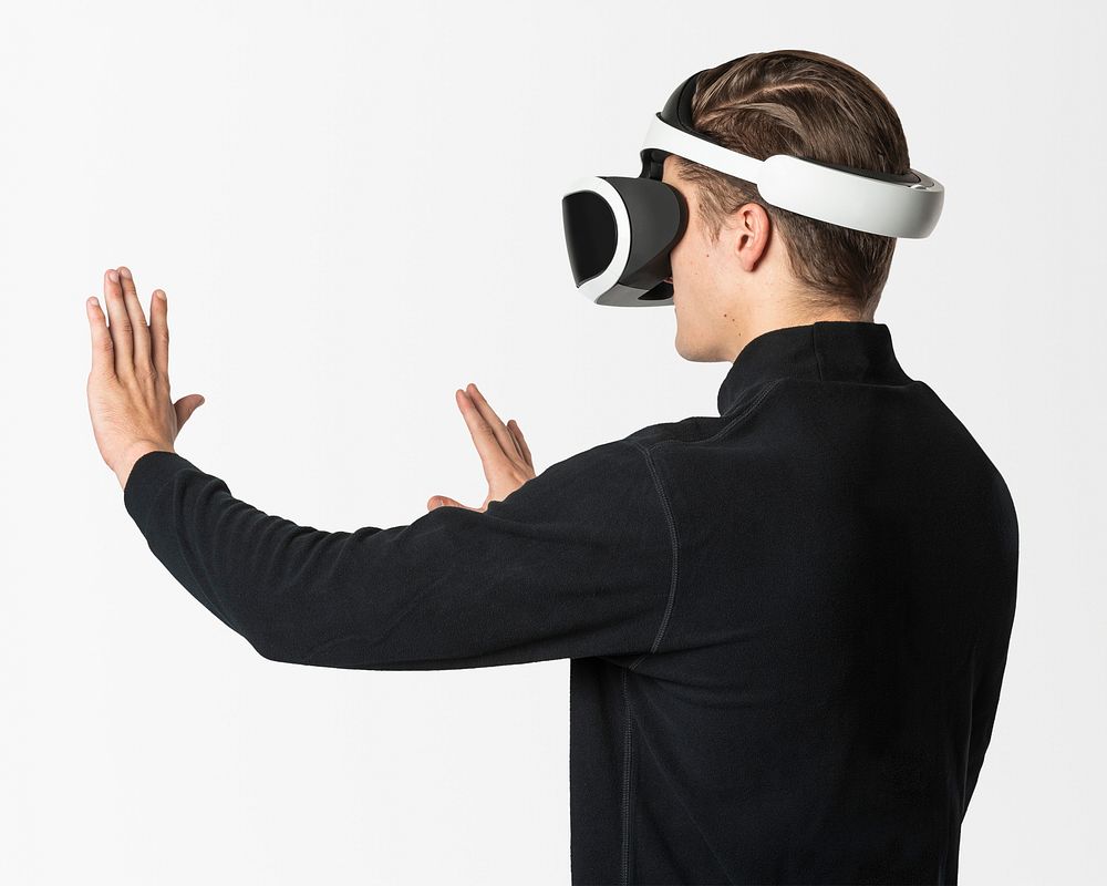 Man in VR headset psd touching invisible screen mockup