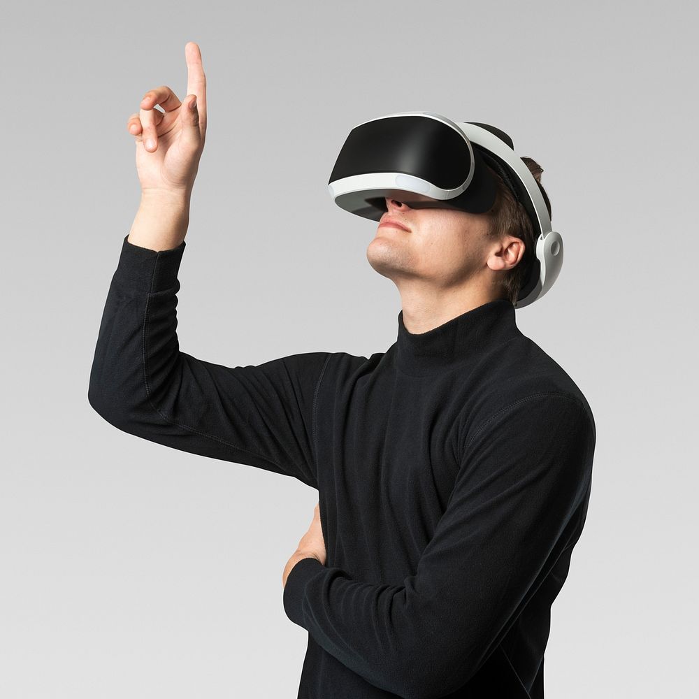 Man wearing VR goggles working on virtual hologram invisible screen