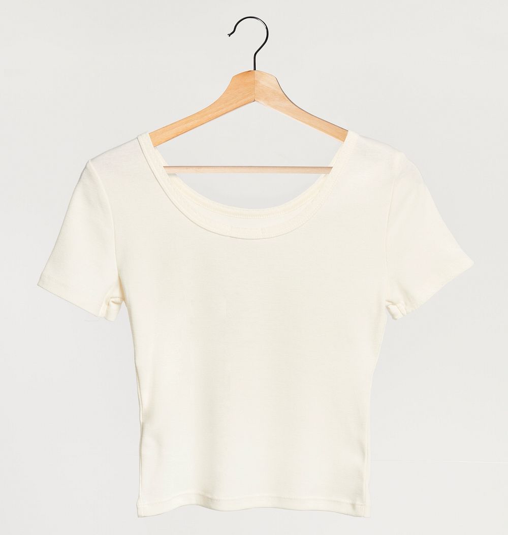 Simple white femat-shirt on a wooden hanger