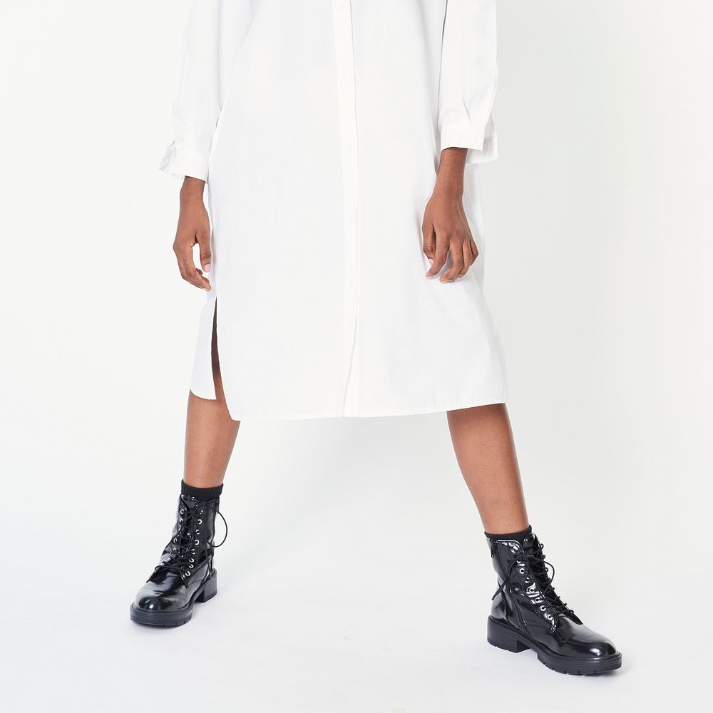 Black woman wearing ankle boots with a white shirt dress 