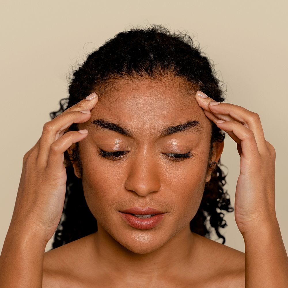 Woman having a headache, and touching her face