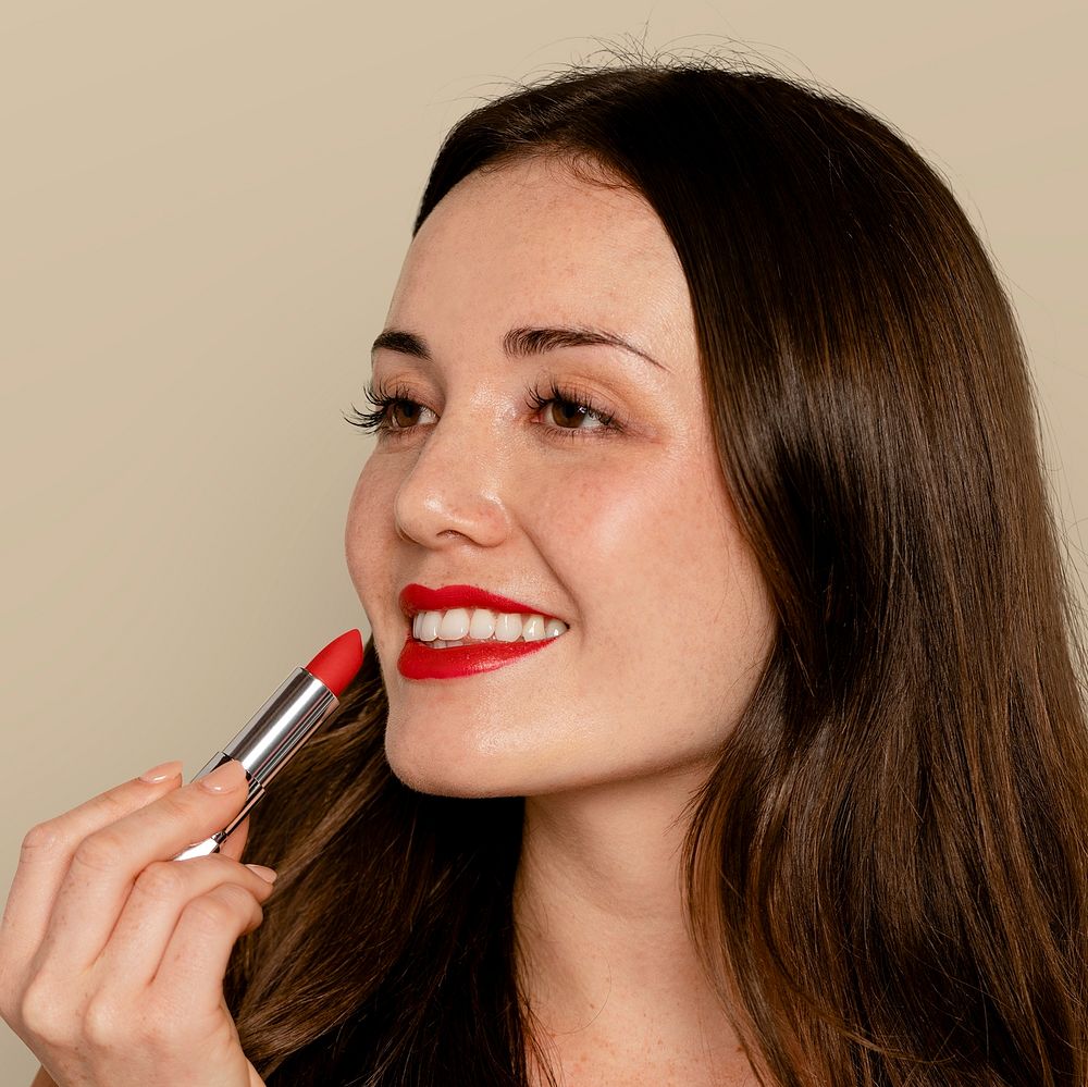 Woman putting on red lipstick, cosmetic & beauty