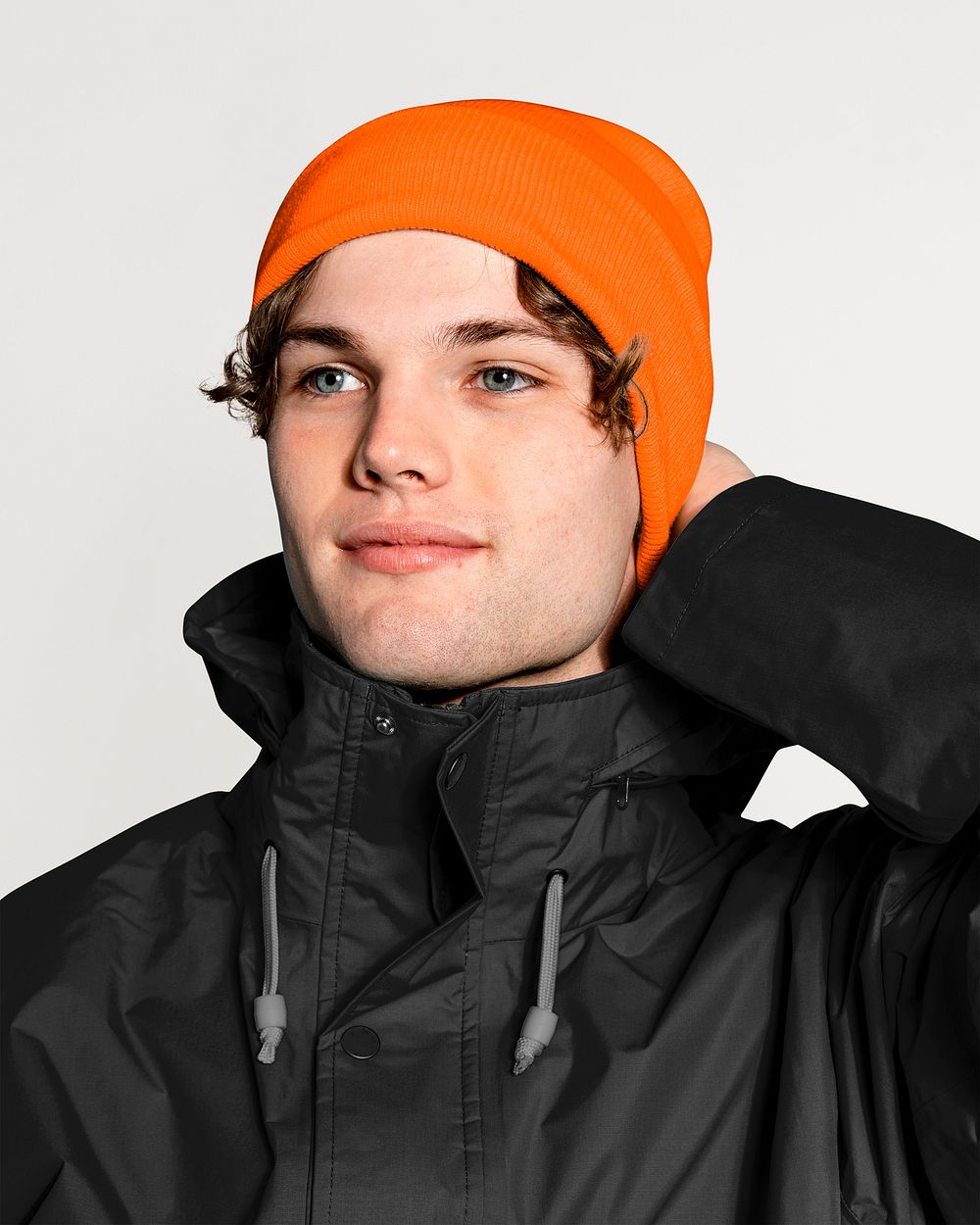 Young man in jacket and woolen hat