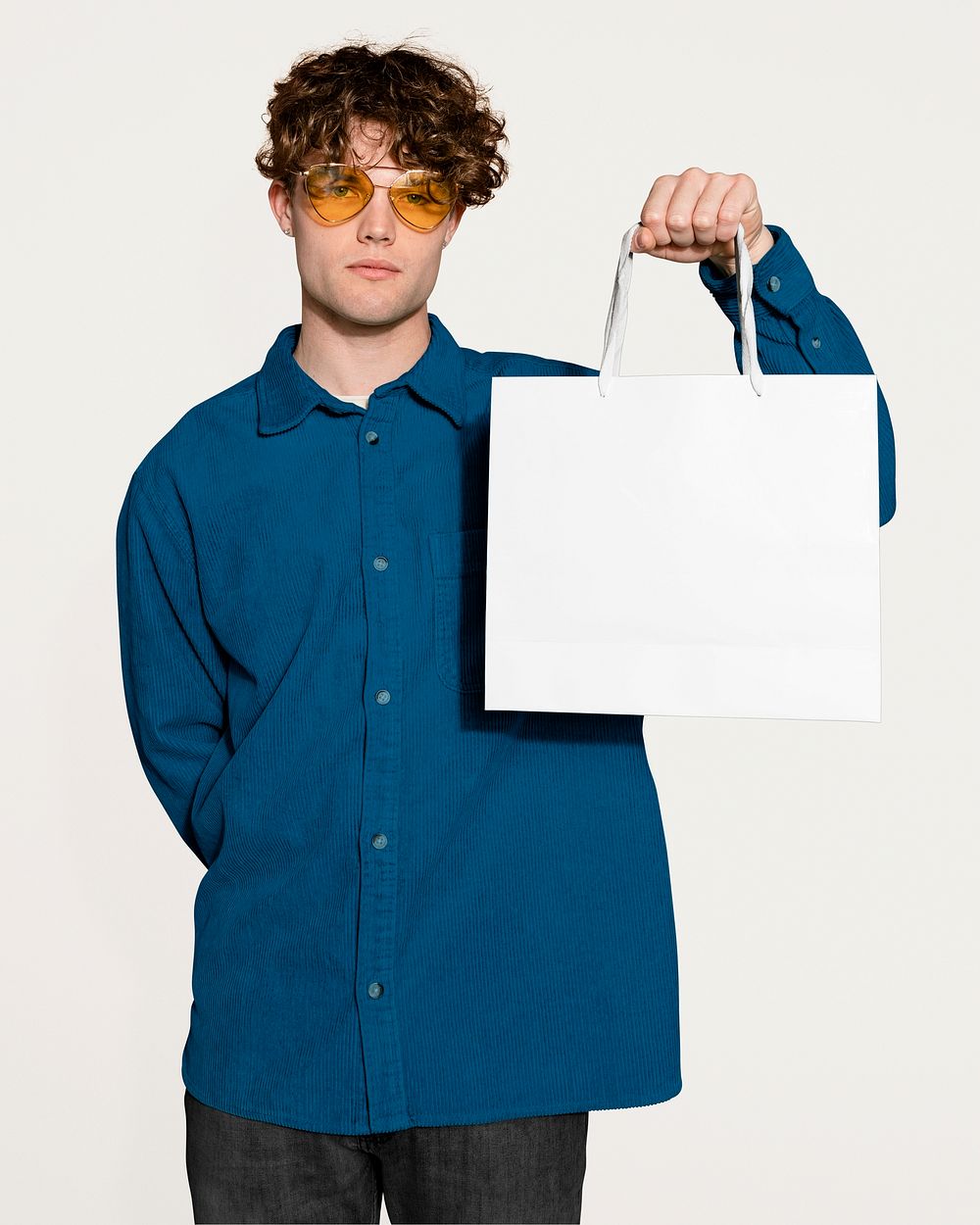 Unhappy man holding shopping bag