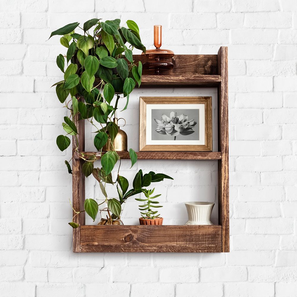 Wooden shelf mockup psd with indoor plants home decor