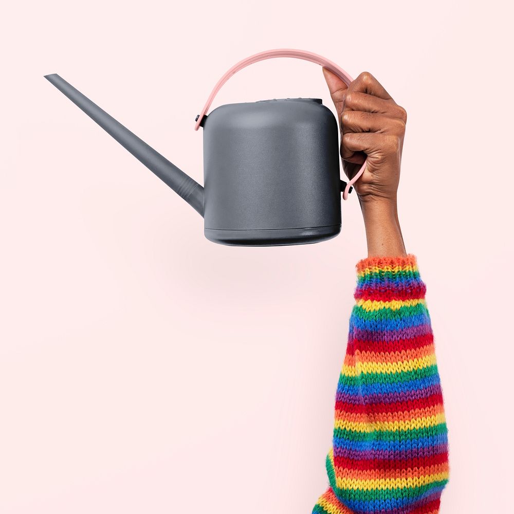 Hand mockup psd holding gray watering can gardening tool