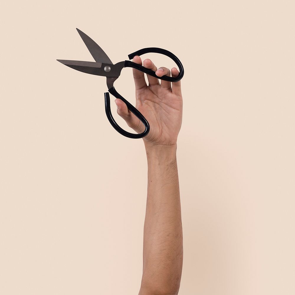 Gardening tool scissor held by a woman's hand