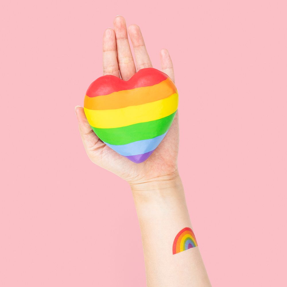 LGBTQ+ community heart with hands presenting