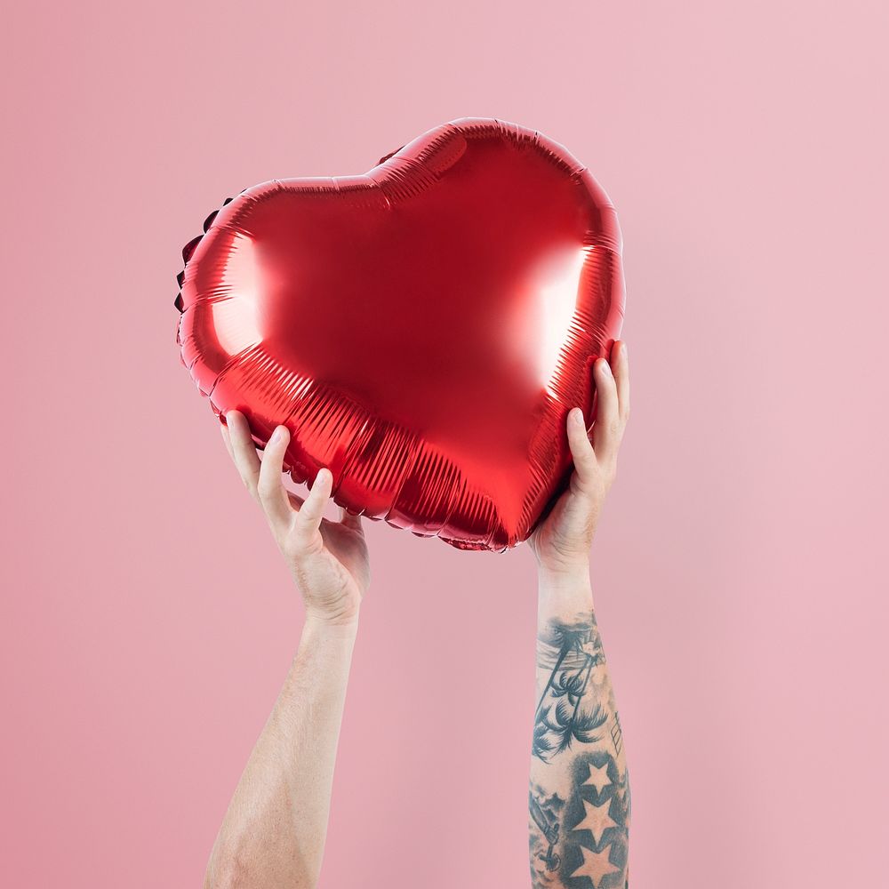 Valentines heart balloon mockup psd held by a person