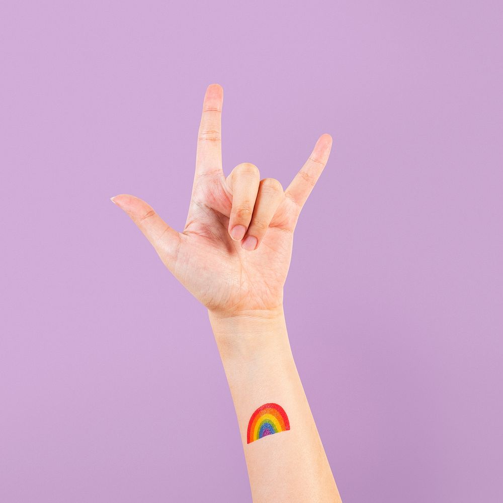 LGBTQ+ pride tattoo mockup psd with rock n' roll hand in the air