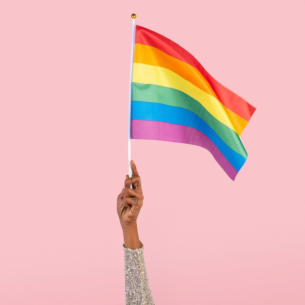 LGBTQ+ pride flag mockup psd with woman&rsquo;s hand raising