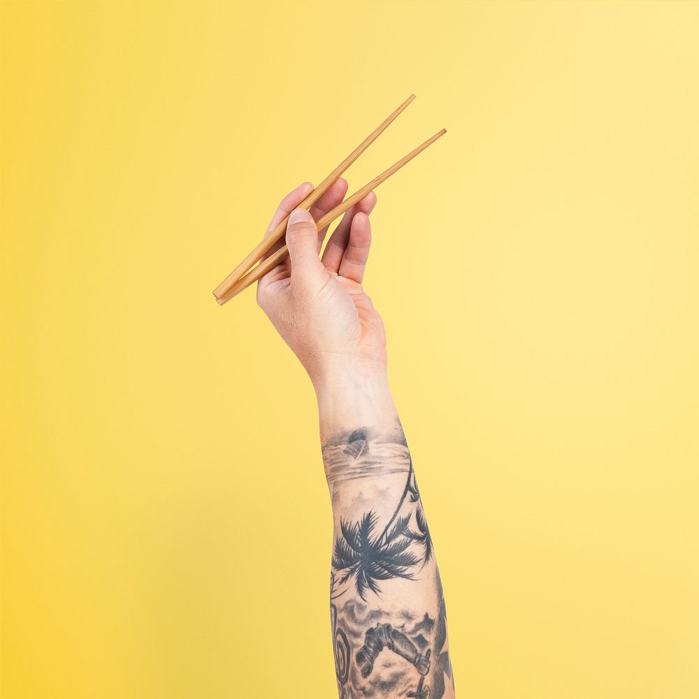 Hand holding chopsticks mockup psd for food concept