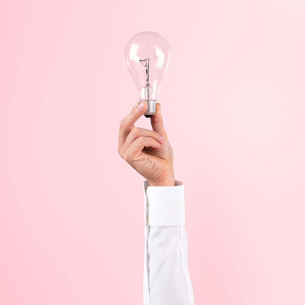 Light bulb creative mockup psd business idea symbol held by a hand