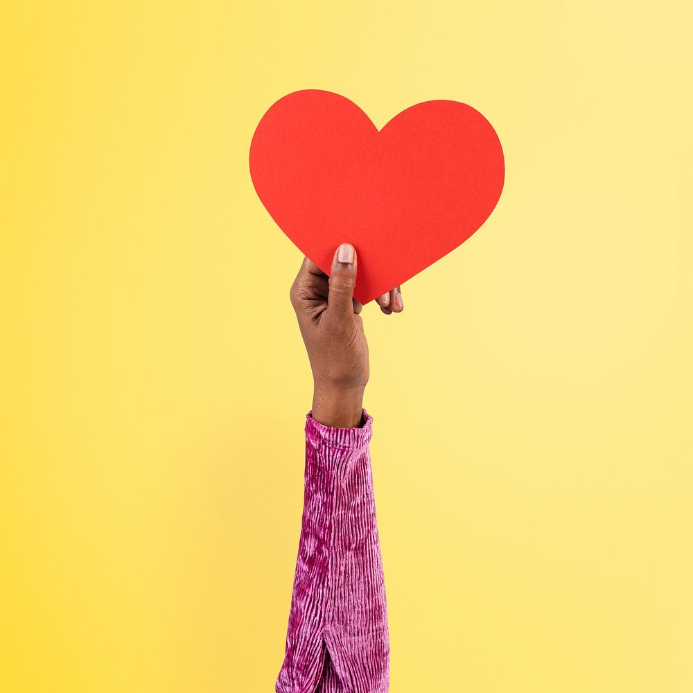 Hand holding heart mockup psd in love and relationship concept