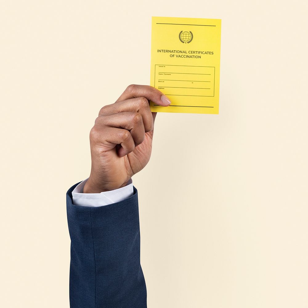 Covid-19 vaccine certificate mockup psd held by a businessman&rsquo;s hand