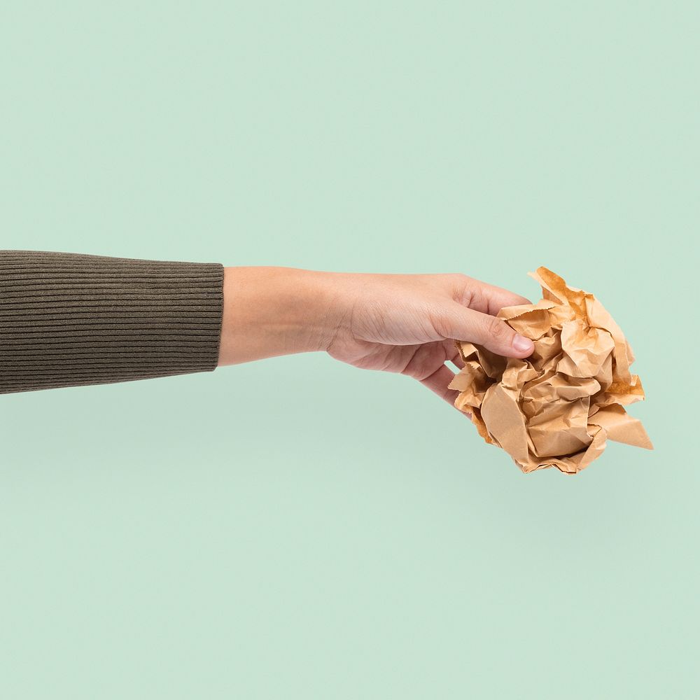 Recyclable paper environment mockup psd held by a hand