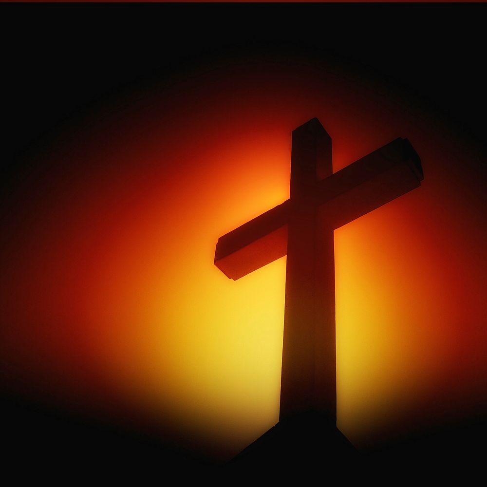 Christian cross on yellow, red and black background. Original public domain image from Wikimedia Commons