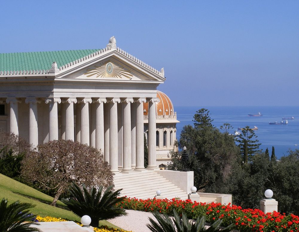 The International Bahá'í Archives building, overlooking the Shrine of the Báb and the Port of Haifa. Original public domain…
