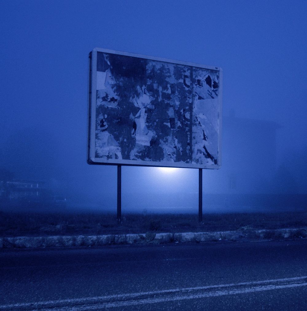 Sign in a foggy night. Original public domain image from Wikimedia Commons