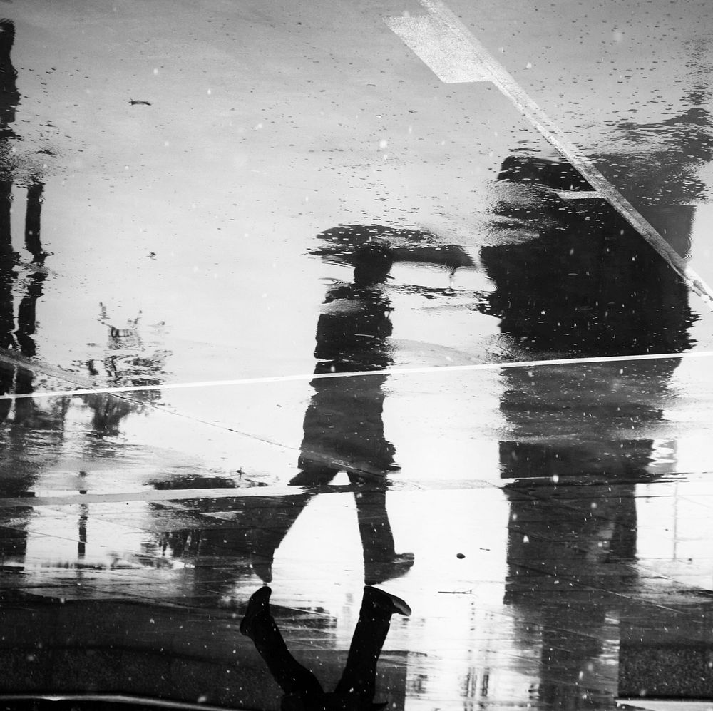 Man reflection on a wet street. Original public domain image from Wikimedia Commons