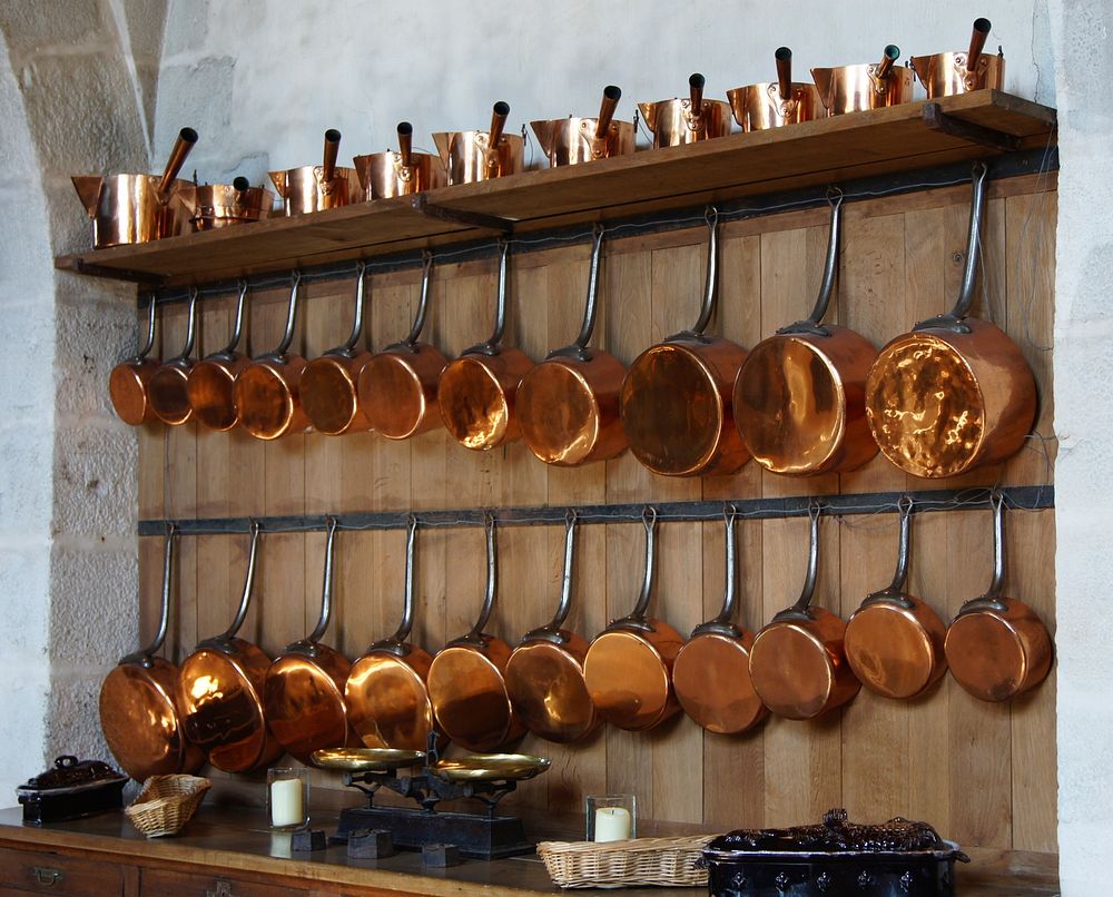 collection of copper saucepans in kitchen of Vaux-le-Vicomte castle. Original public domain image from Wikimedia Commons