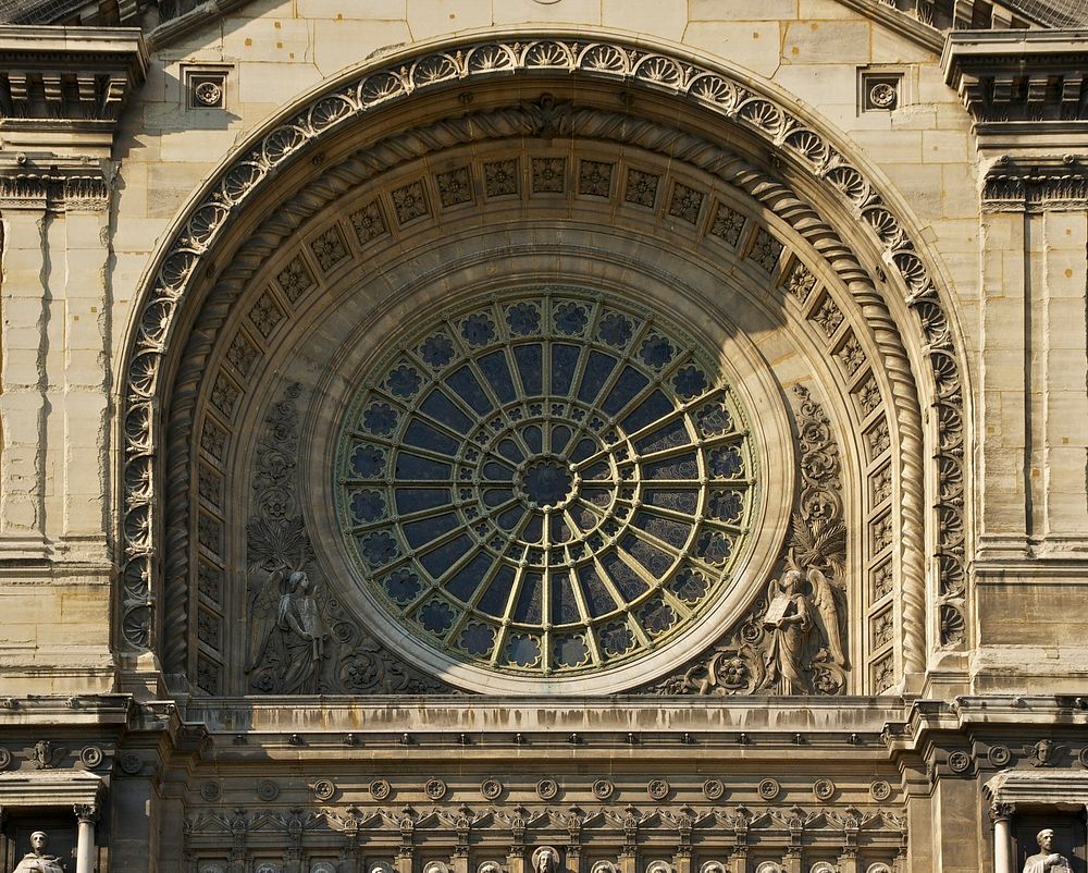 The rose window above the main portal of the Saint-Augustin church in Paris. Original public domain image from Wikimedia…