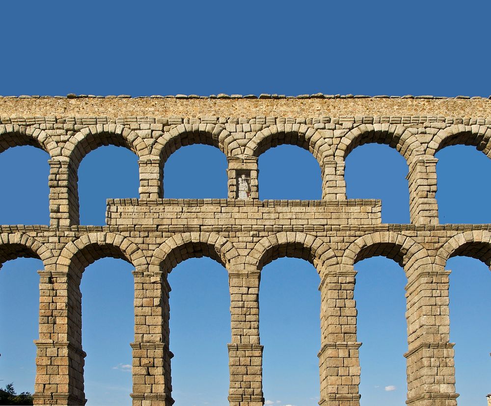 The central part of the roman aqueduct, with the niche and the statue of Madonna and Child, Segovia, Spain. Original public…