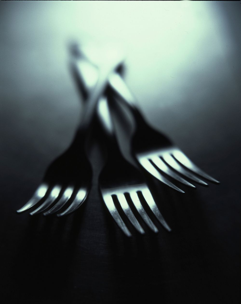 Three forks staked on the table. Original public domain image from Wikimedia Commons