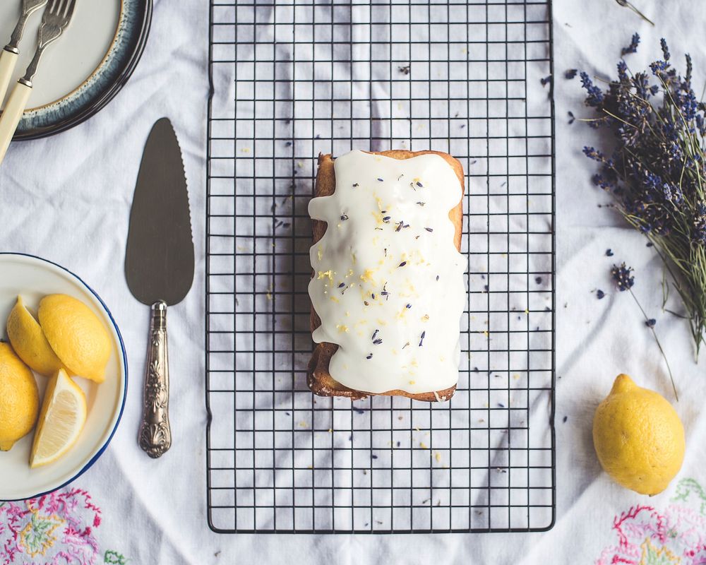 Freshly baked lemon cake with icing and lavender flowers. Original public domain image from Wikimedia Commons