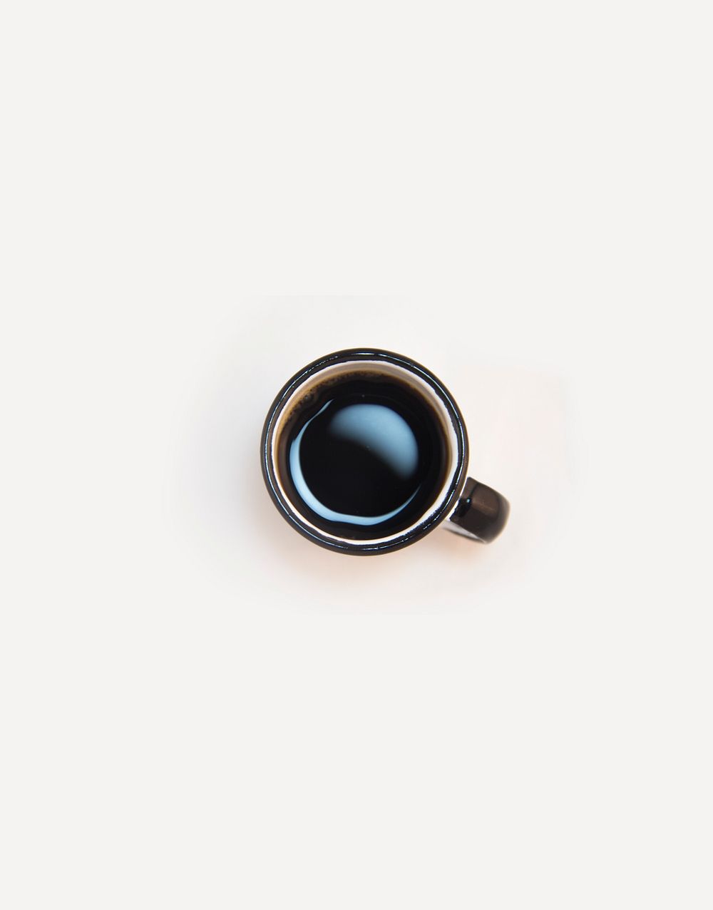 Flat lay photography of a cup of black coffee in São Paulo.. Original public domain image from Wikimedia Commons