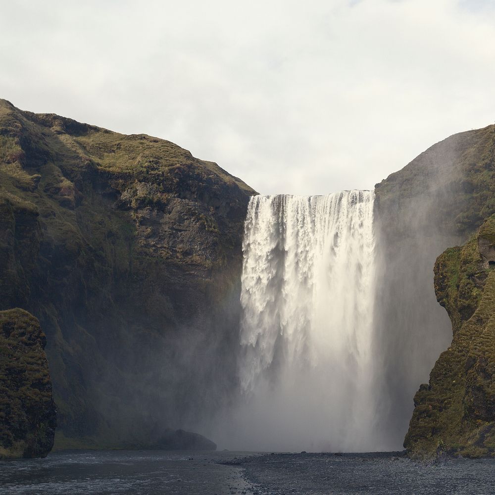A large waterfall streaming from a rocky mountain in Iceland. Original public domain image from Wikimedia Commons