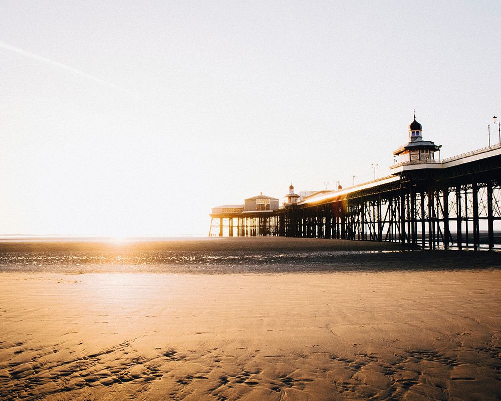 View from the sand beach on the pier during sunset in Blackpool. Original public domain image from Wikimedia Commons