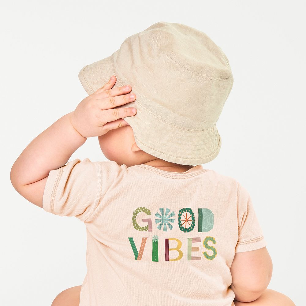 Cute toddler in Good vibe t-shirt, minimal beige design