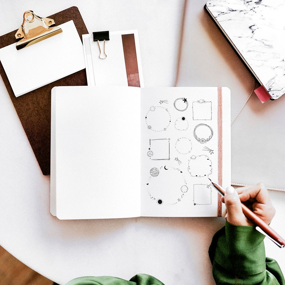 Woman drawing doodles in a notebook mockup