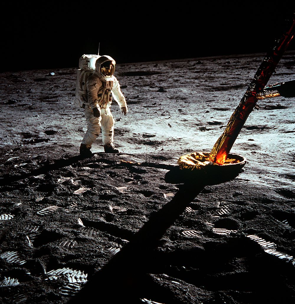 Astronaut Edwin E. Aldrin Jr., lunar module pilot, walks on the surface of the moon near a leg of the Lunar Module during…
