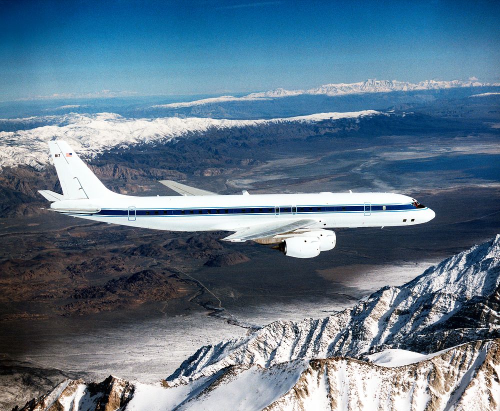 The DC-8 in flight near Lone Pine, Calif. In the foreground are the Sierra Nevada Mountains, covered with winter snow. In…