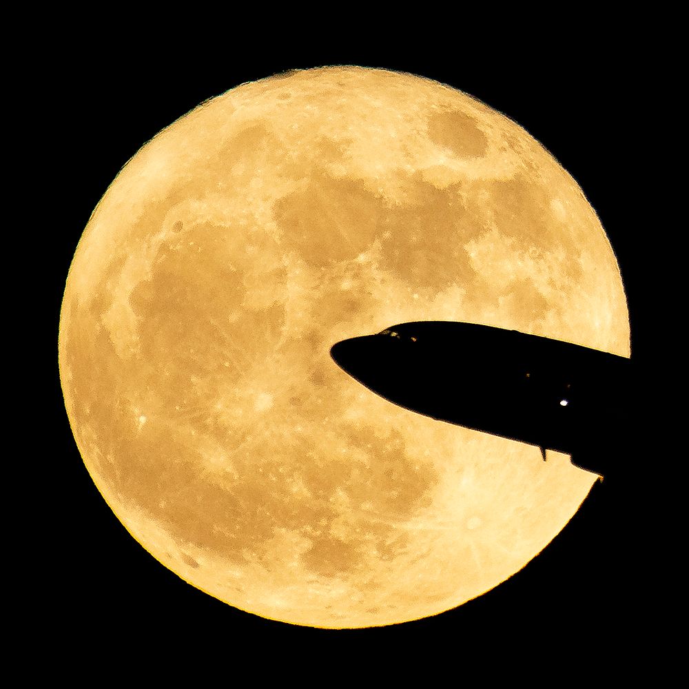 Aircraft taking off from Ronald Reagan National Airport is seen passing in front of the Moon as it rises in Washington…