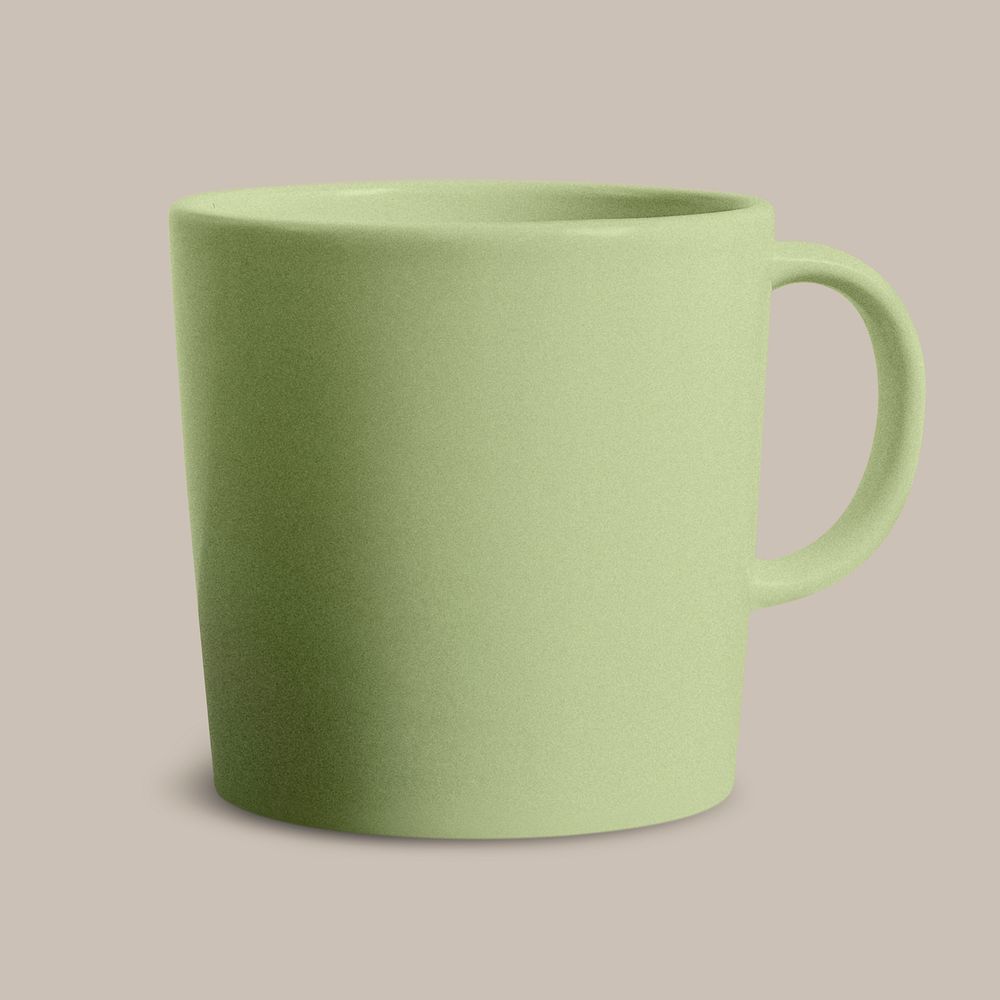 Green ceramic coffee cup on beige background
