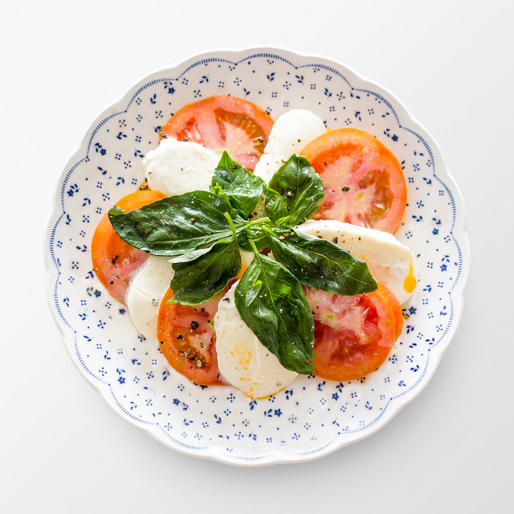 Caprese salad on a plate, Italian cuisine on white background, food photography