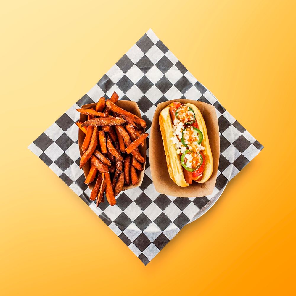 Hot dog meal on orange background, food photography