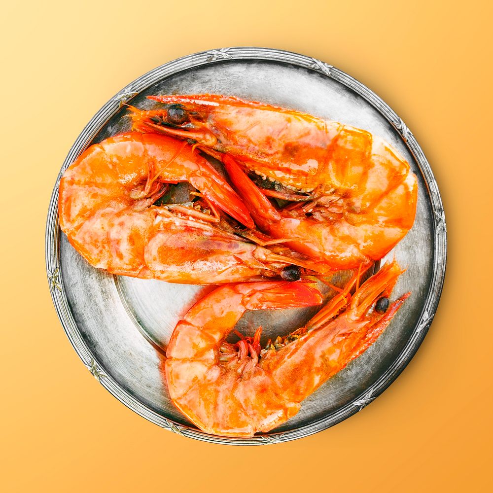 Cooked prawn on a plate, seafood on orange background, food photography